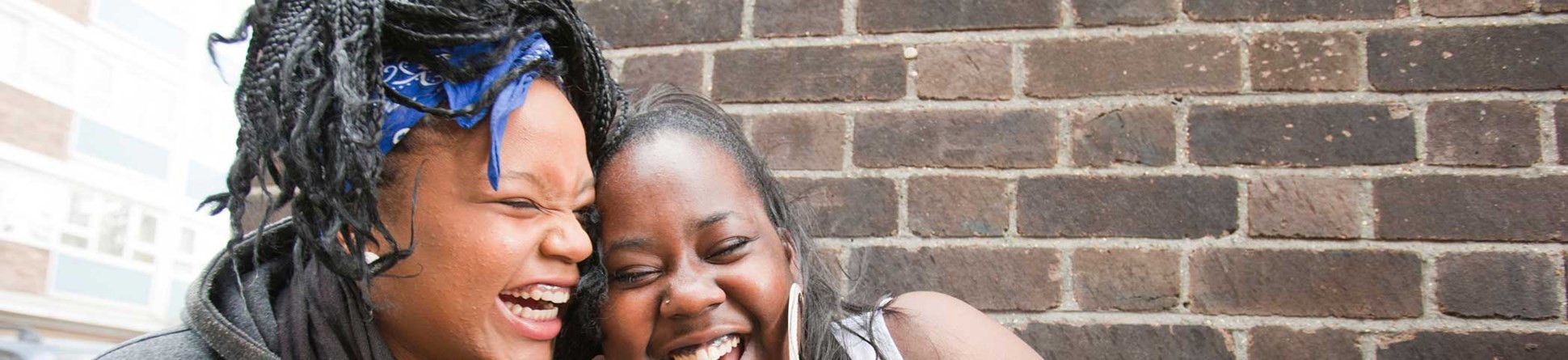 Two Black girls laughing together