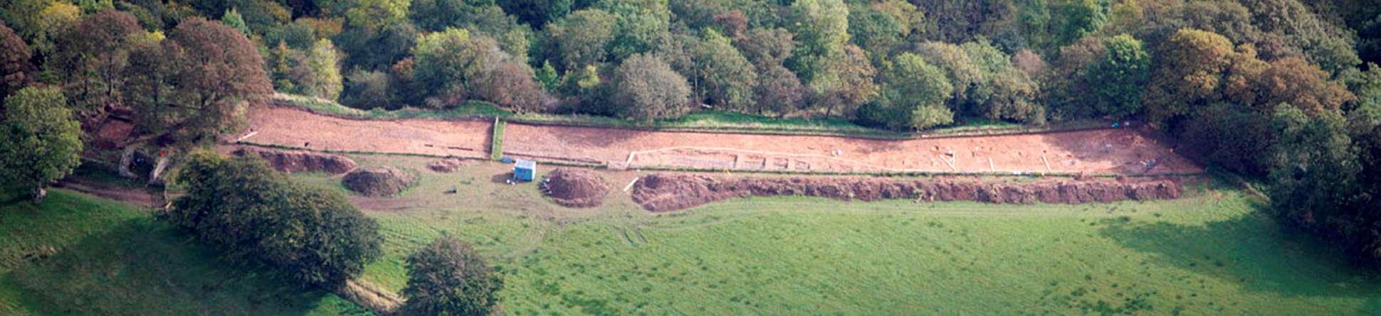 Aerial photograph showing an excavated strip of field at the top of a river cliff at Birdoswald Roman cemetery